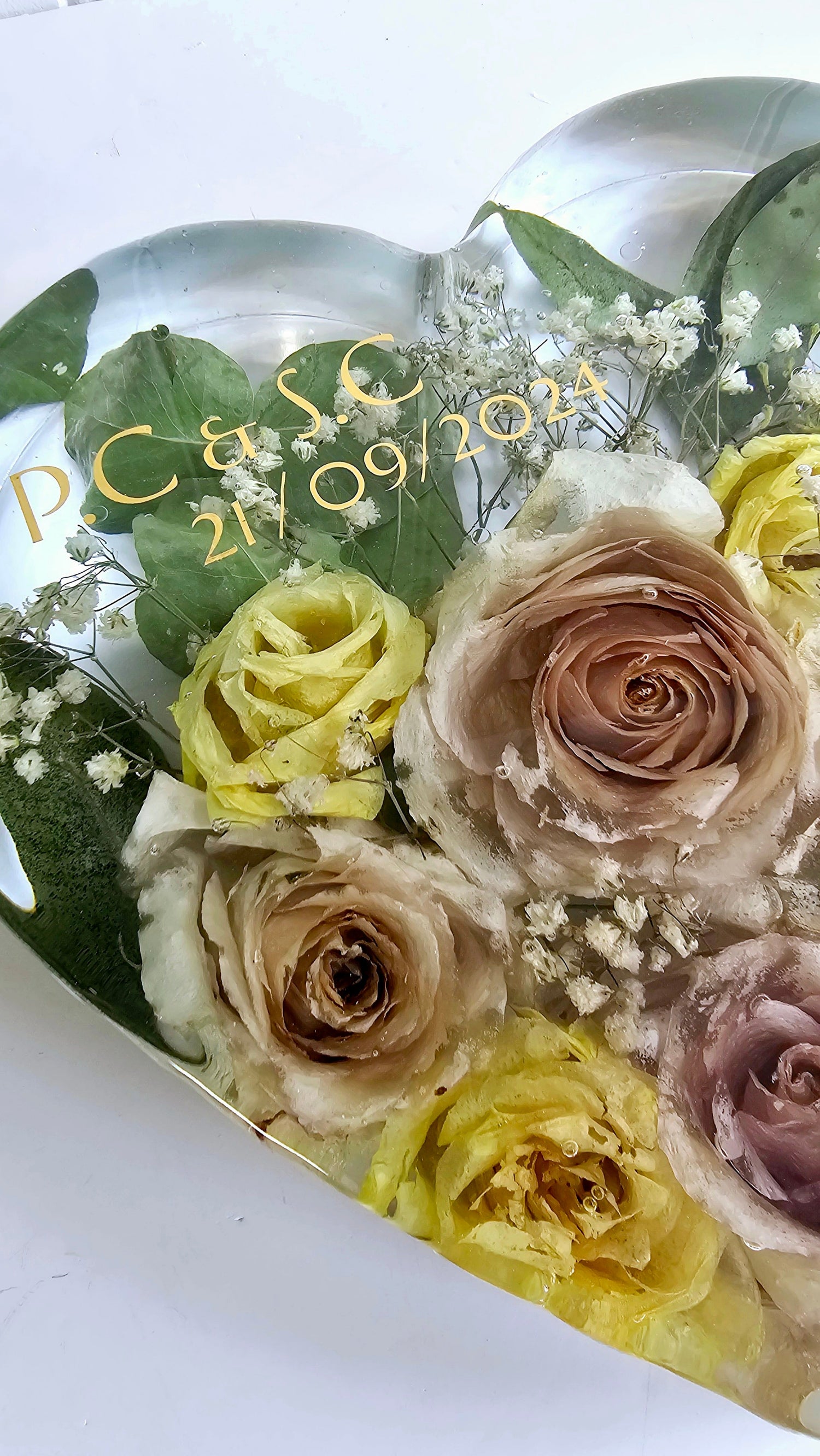Heart-shaped bouquet of yellow and brown roses with personalized text on a white background