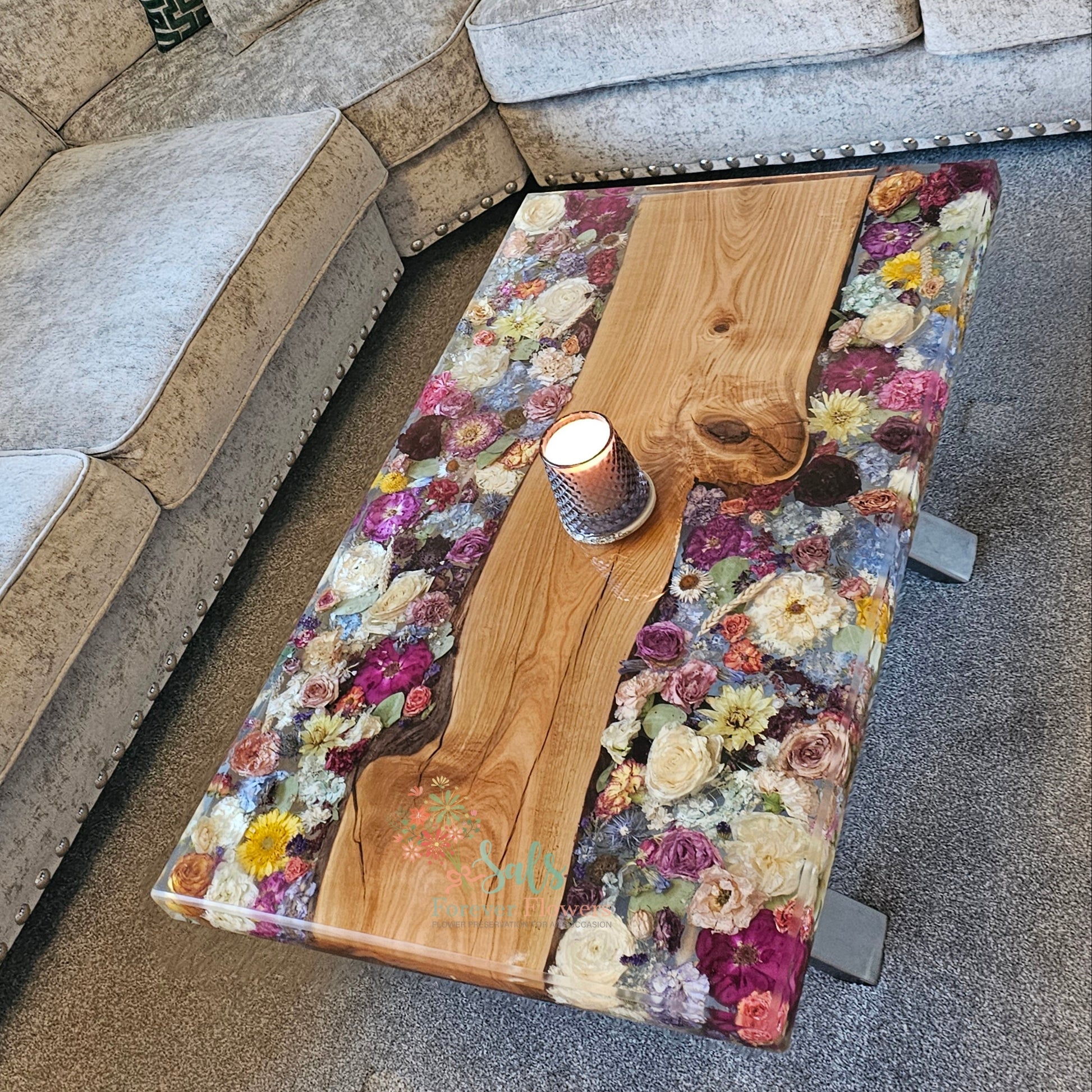 Sectional sofa with a floral and  wooden coffee table in a living room setting.