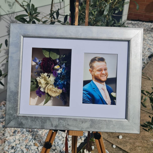 silver frame with funeral flowers preserved on one side and a photo of teh loved one displayed 