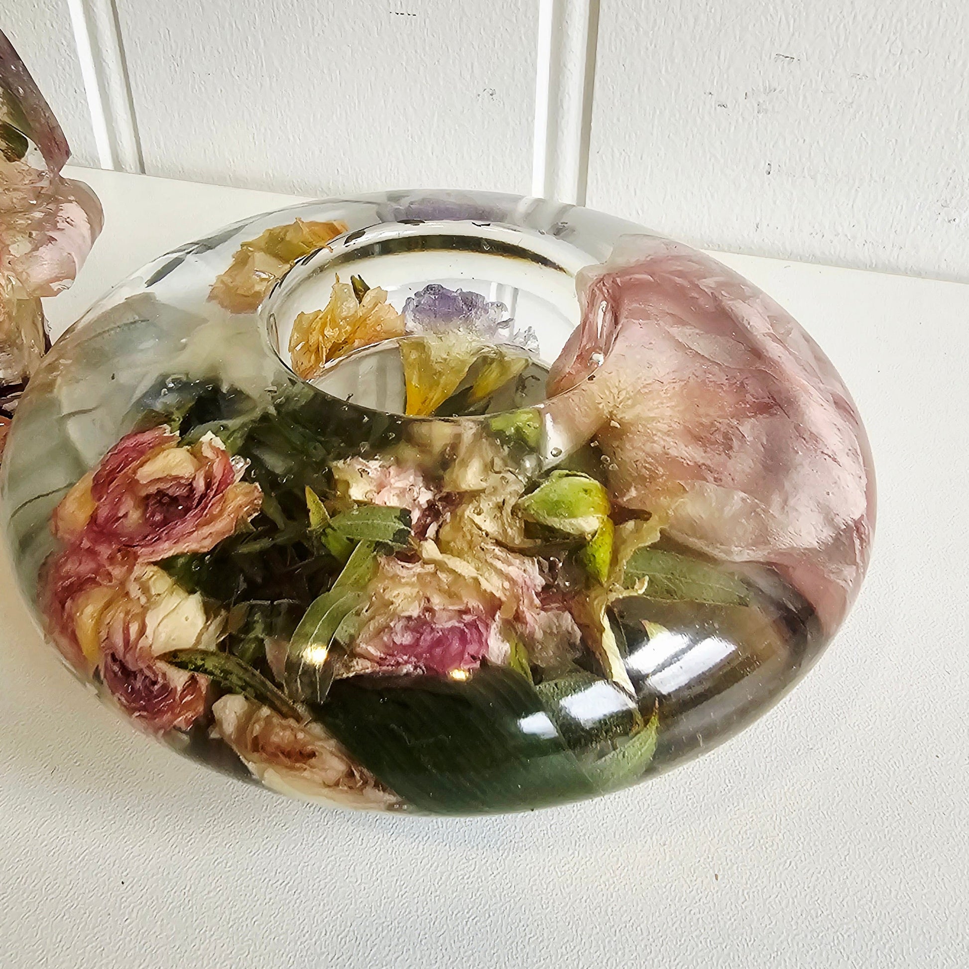 flat resin tealight holder with a button hole preserved within it