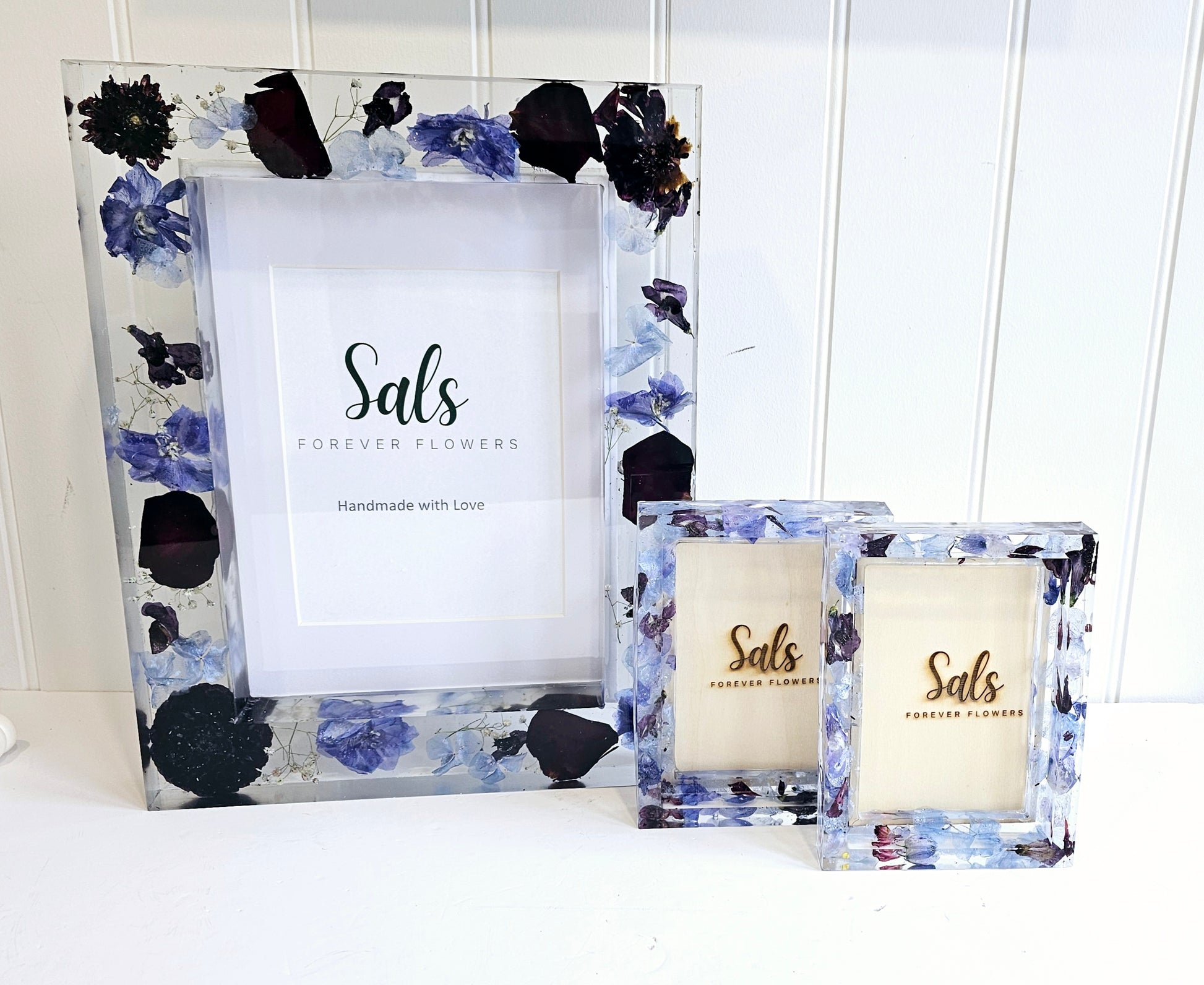 Decorative photo frames with floral design and 'Sals Forever Flowers' branding.
