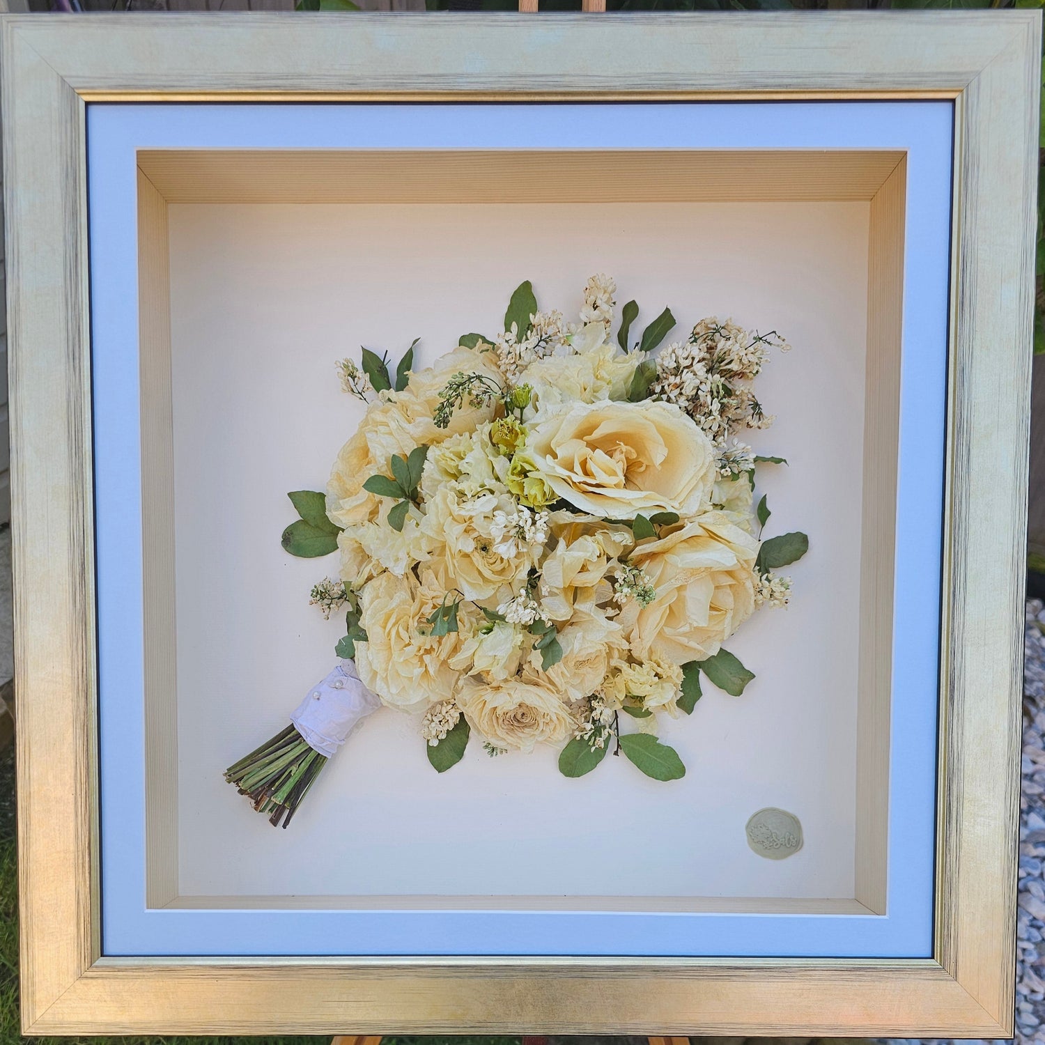 Framed bouquet of flowers on a grassy background
